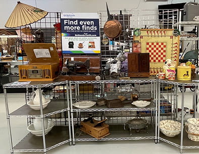 Store shelves showing ceramics, a record player, and vintage games