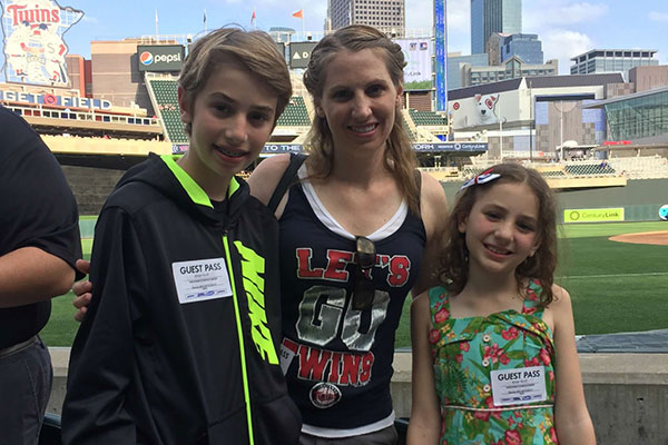 mom with children outside at a twins game